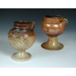 Two 19th century brown salt glazed wet drug jars, both with spouted bun shaped bodies raised on
