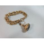 An 18ct gold bracelet with a carved intaglio fob, the two row anchor link bracelet, hallmarks worn