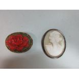 A carved shell cameo of Psyche together with a carved lacquer brooch, the first brooch of pale