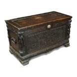 An early 17th century Continental carved wood cassonne, with plain panel top, carved panel front
