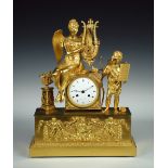 An Empire ormolu mantle clock, the classical style case with winged female playing the lyre, an