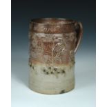 Attributed to Vauxhall, a brown salt glazed mug, inscribed 'Wm Mott 1726', above an oval profile