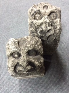 A pair of carved stone gargoyles with grotesque faces 15 x 16 x 30cm (6 x 6 x 12in)