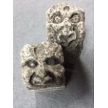 A pair of carved stone gargoyles with grotesque faces 15 x 16 x 30cm (6 x 6 x 12in)