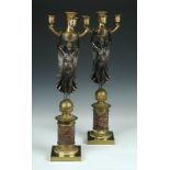 A pair of Regency ormolu and bronze candelabra, each with the four anthemion cast nozzles held up by