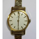Omega - a lady's gold plated wristwatch, circa 1961/62 having a silvered dial with gold baton