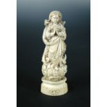 A carved ivory Indo-Portuguese Madonna, probably Goan 19th century, carved with hands folded in