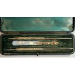 A Victorian 9ct gold three piece writing set, by William Harrison Walter, Birmingham 1897,