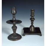 Two 17th/18th century brass candlesticks, the turned column of the English stick on a dished