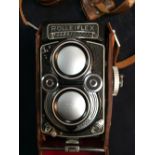 A leather cased Rolleiflex 3.5F camera, circa 1960, serial number 2232247 with ring gear shutter and