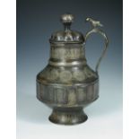 A silver inlaid brass covered ewer, possibly 13th century Mosul, the bud shaped lobes on the lid and