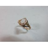 A 19th century topaz ring, the oval cut pale pinkish topaz triple claw set to a pierced trellis
