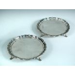 A pair of silver waiters, by The Barker Brothers and Sons, Birmingham 1928, each circular with