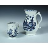 A Lowestoft blue and white jug printed with a workman, tool over his shoulder as he walks by two