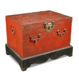 A 19th century Chinese red lacquer chest on stand, with heavy brass side handles, clasp and lock