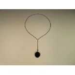 An art deco Tiffany & Co black enamel pendant and matching chain, the hexagonal pendant enamelled on