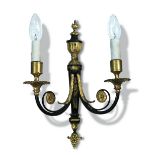 A set of four parcel gilt bronze two branch wall lights, the candle nozzles above gadrooned drip