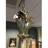A gilt metal hall lantern in the Venetian style, the six shaped concave glazed sides with
