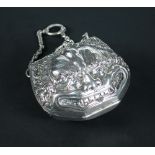 A Victorian silver necessaire, by Louis Dee, London 1883, of purse shape, embossed with grotesque