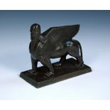 An early 20th century bronze figure of an Assyrian human headed winged lion, the beast standing on a