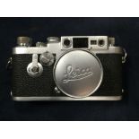 A leather cased 1957 Leica III G camera with Summicron chrome f=5 1:2 lens, the body numbered 904227