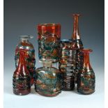 A collection of Mdina ribbon trailed glass, comprising a tall bottle form, a near pair of shorter