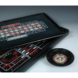 A vintage casino set, the reversible top with Black Jack and Roulette boards, lifting off to