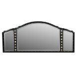 A Cotswold School ebonised overmantle mirror, possibly by Kenton & Co., the three arched panels