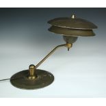 An American enamelled desk lamp, the grey enamelled two-tier shade to an angled brass arm and