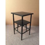 After E. W. Godwin, an ebonised side table, the square top supported on four ring turned legs,