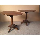 A pair of early 20th century mahogany oval occasional tables, each supported on a tapering square