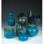 A collection of Mdina blue glass wares, comprising a tall slender bottle form, another bottle and