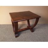 An Art Deco walnut occasional table, the rounded rectangular top raised on U-end supports united