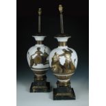 A pair of gilt decorated milk glass table lamps in the manner of Fornasetti, the baluster forms
