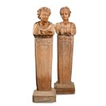 A pair of Art Nouveau style terracotta busts on stands, each bust upon a plinth base and raised on