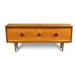 A 1970's teak sideboard by H. Lait & Sons Ltd., London, the rectangular top above pairs of