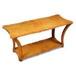 An Art Deco burr maple coffee table, possibly by Epstein, the shaped rectangular top on four swept