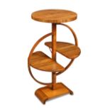 A 1930's Art Deco walnut folding occasional table, the circular top above two folding demi-lune