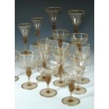 MVM Cappellin, Murano, a set of 31 amber glass drinking glasses, c.1925, of various sizes, each with