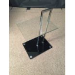 After Eileen Gray, a chrome and glass occasional table, the rectangular clear glass top raised on