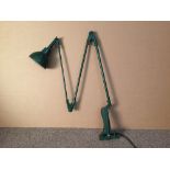 An industrial green painted angle poise lamp, with drilled rectangular mounting plate