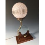 An Art Deco oak and brass table lamp and photograph frame, the circular glass photograph holder to
