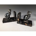 A pair of Art Deco bookends modelled as cats, signed M. Font, each spelter model sat upon a