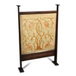 In the manner of C. F. A. Voysey (British, 1857-1941), a walnut framed firescreen, the tapering