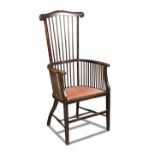 Liberty & Co., a stick back elbow chair, the stained frame with a padded seat raised on tapering