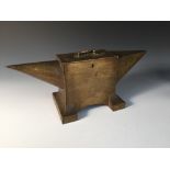 A novelty metal cash tin in the form of an anvil, the hinged cover with lift up handle 18 x 43 x