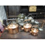 Three 19th century copper range kettles, a large collection of Victorian britannia metal tea pots, a