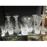 A quantity of assorted glasswares to include four candlesticks, two decanters and drinking glasses