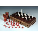 An Indian bone red and white chess set, leather mounted board and dice shakers, the set ring turned,