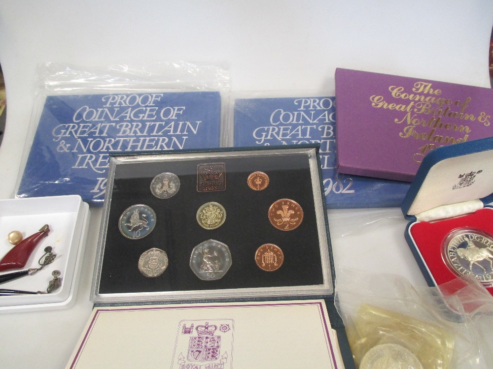 A small collection of loose coins, including pre-decimal coinage sets, silver proof crown and
